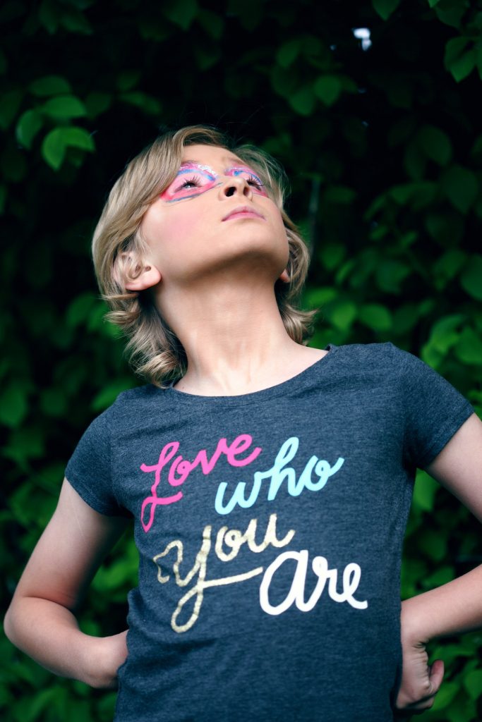 A photo of a child wearing a shirt that says "Love Who You Are" - an important reminder throughout your self discovery journey is to love yourself at every point.